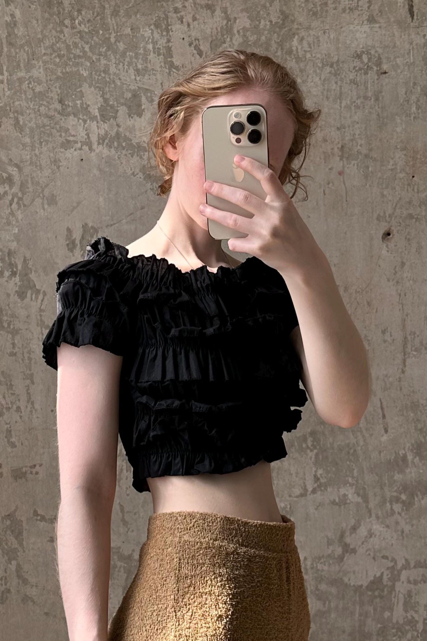 A person is taking a selfie with a smartphone, holding the phone up to their face to capture the image.