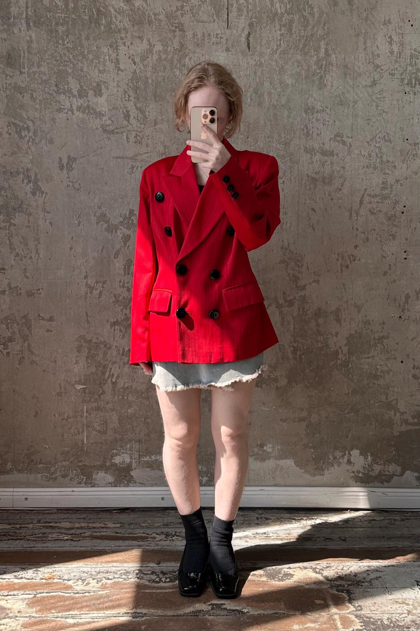 a woman wearing a red jacket and black boots