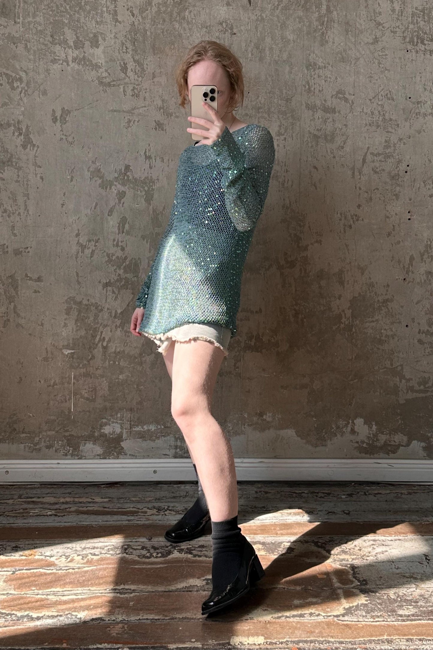 a woman taking a selfie in front of a wall