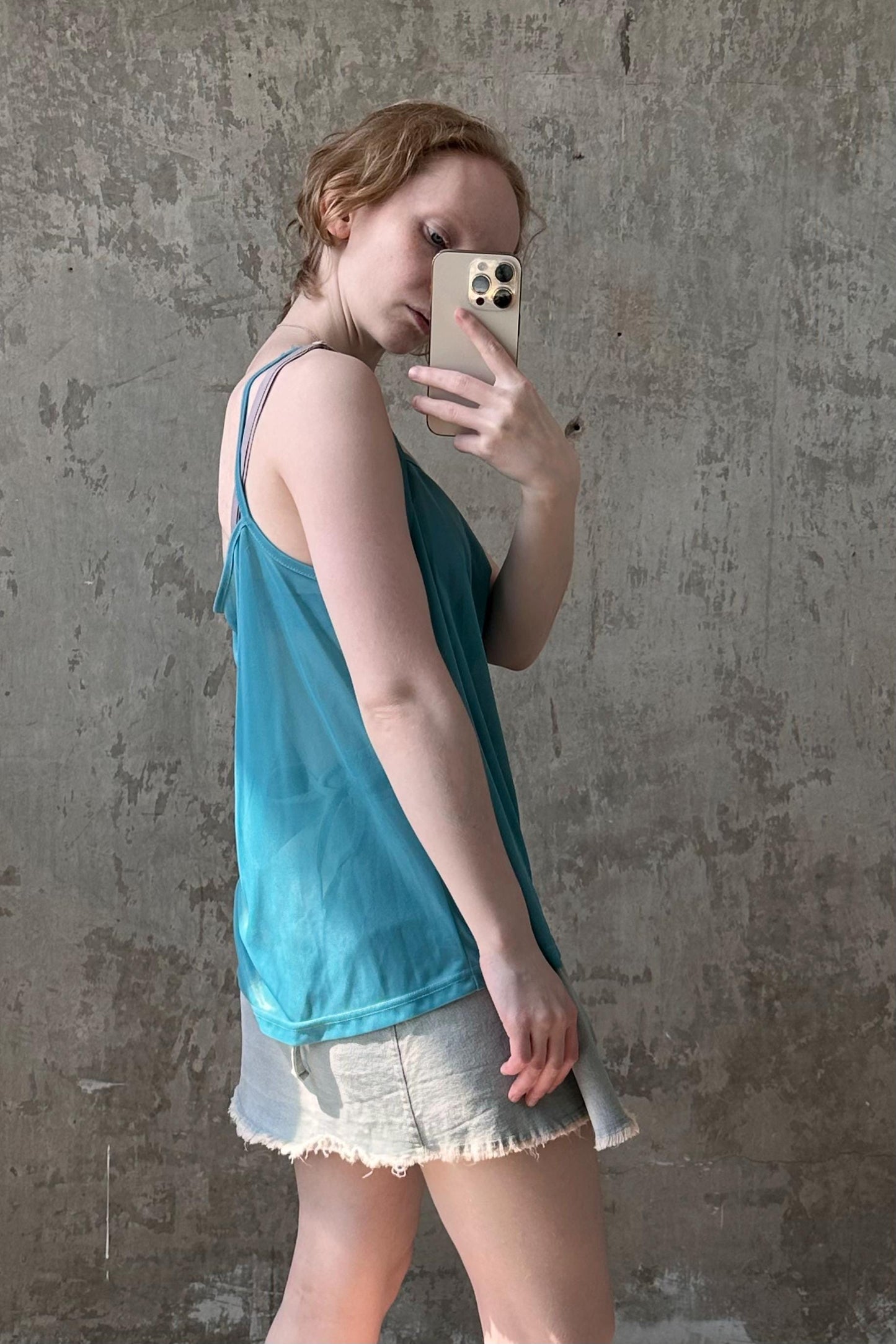 a woman walking while holding a cell phone