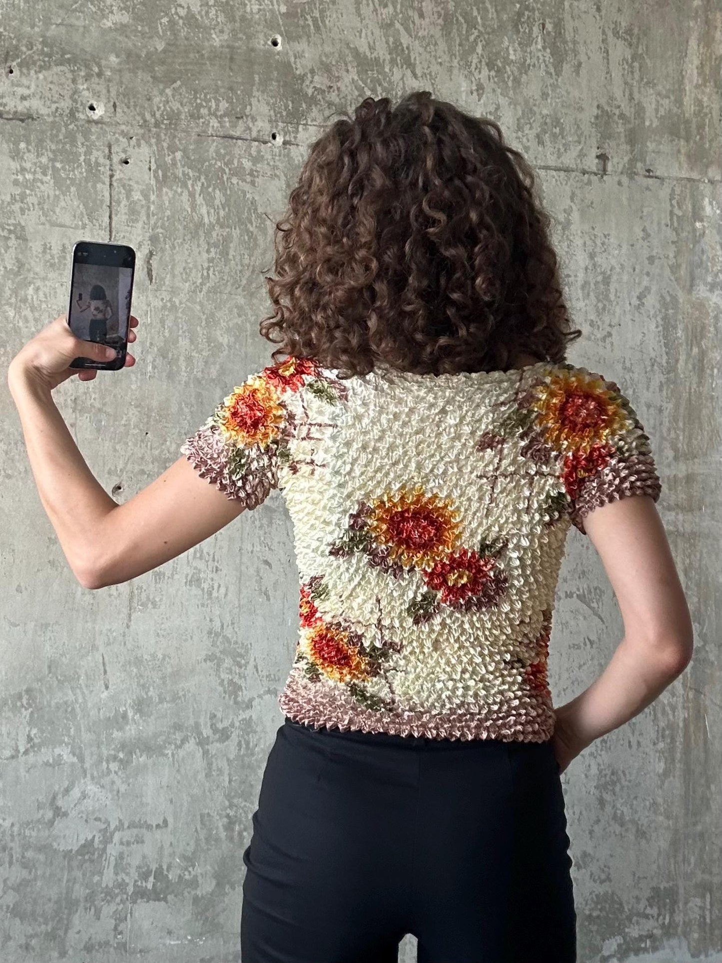a person taking a selfie with a smartphone, holding the device up to their face to capture the photo.