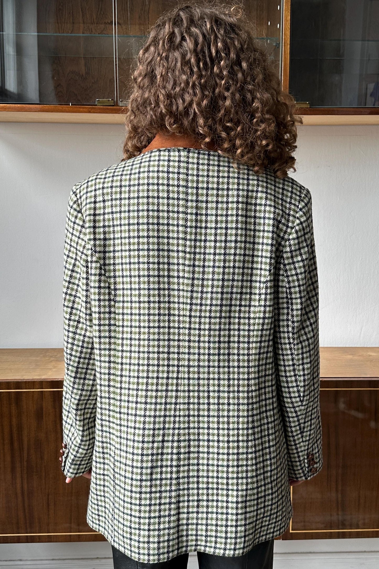 the back of a person wearing a black and white checkered jacket.