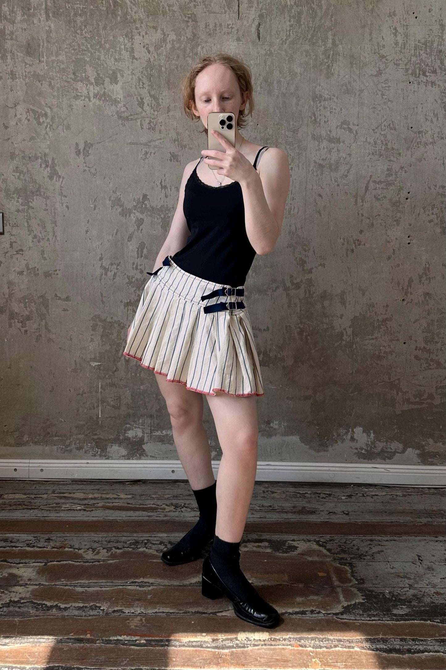 a woman taking a picture of herself with her cell phone
