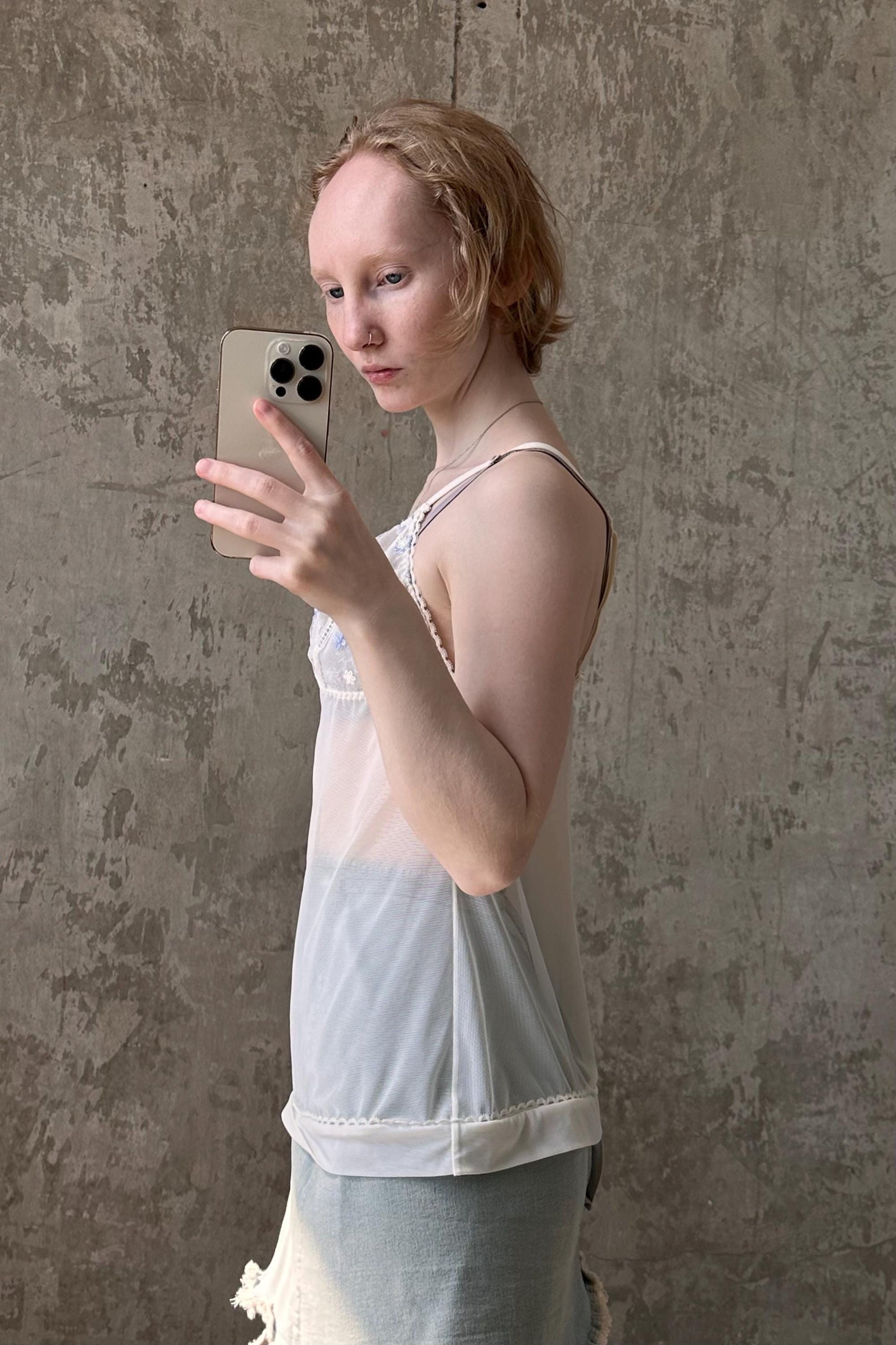 a woman holding a cell phone up to her face