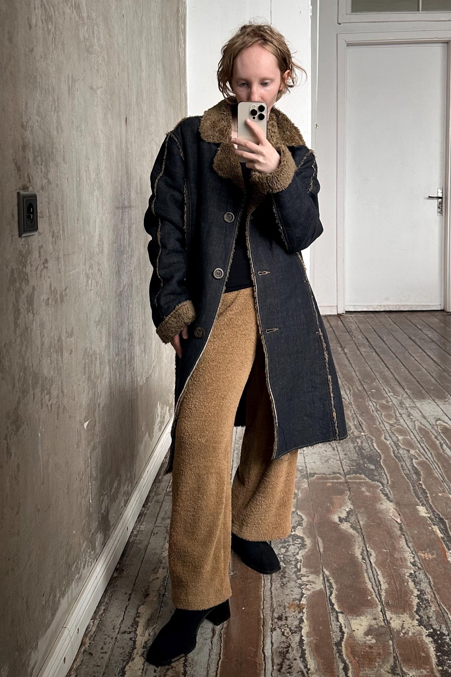 a woman taking a picture of herself in a mirror