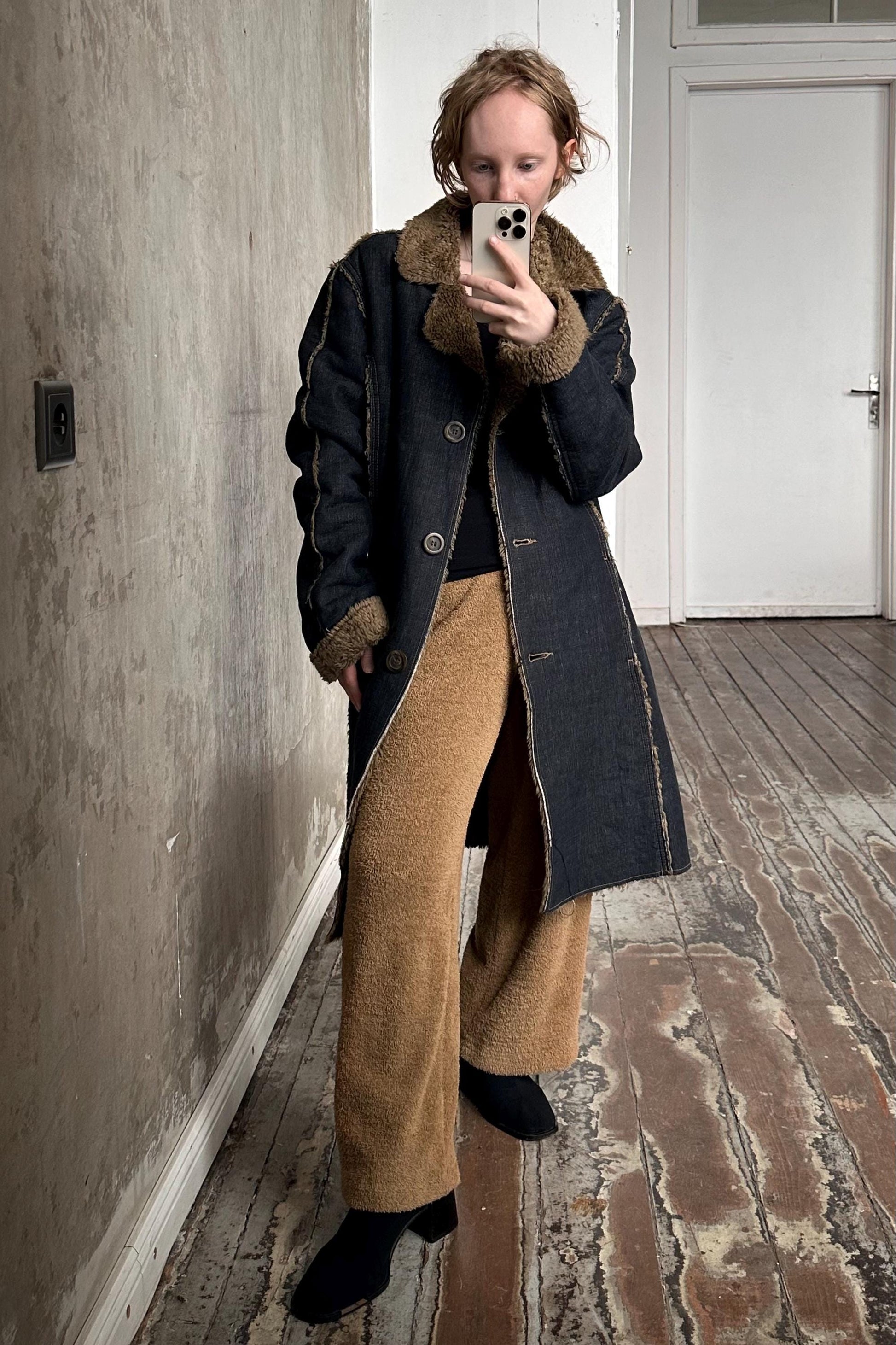 a woman taking a picture of herself in a mirror