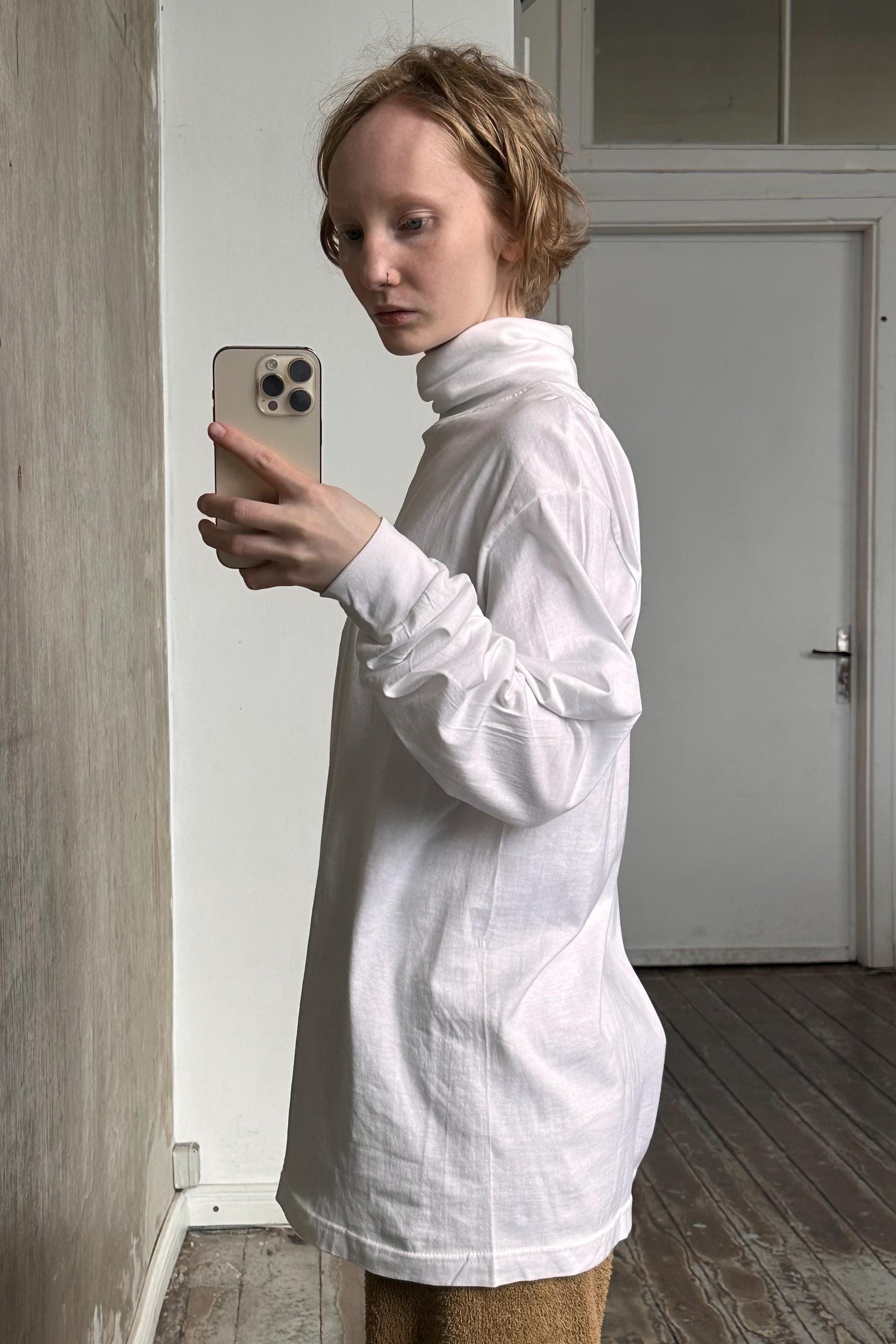 a woman taking a picture of herself with her cell phone