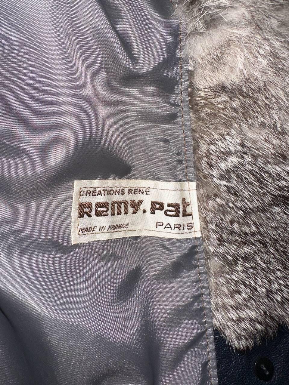 a close-up view of a grey fabric with a label attached to it, which appears to be a label for a product.