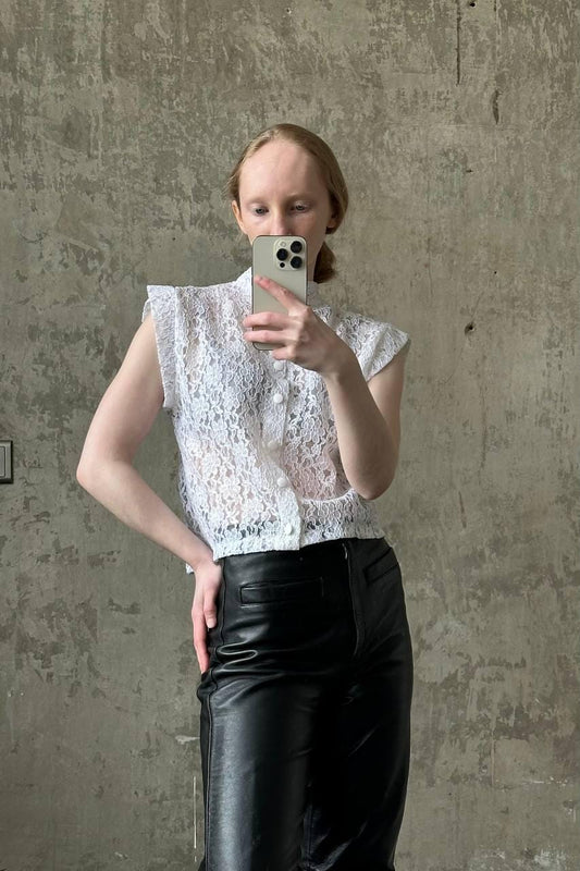a woman taking a picture of herself in a mirror