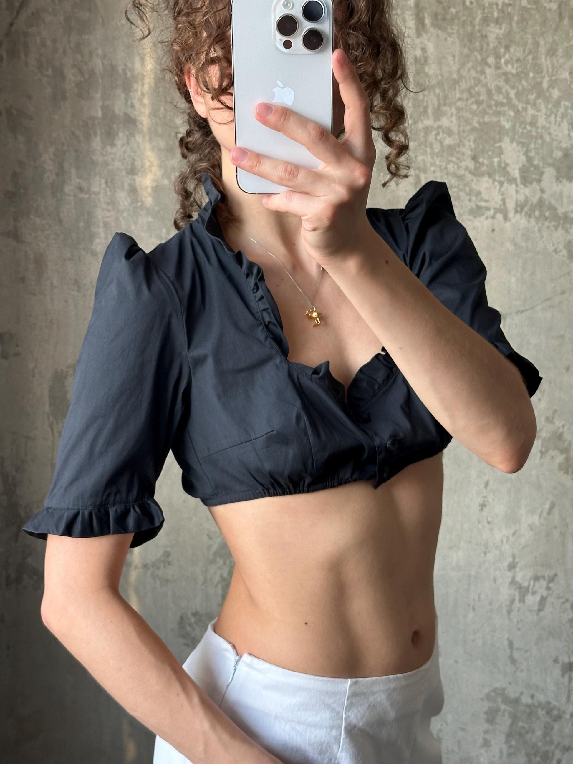 A person is taking a selfie with a smartphone, holding the phone up to their face to capture their image.