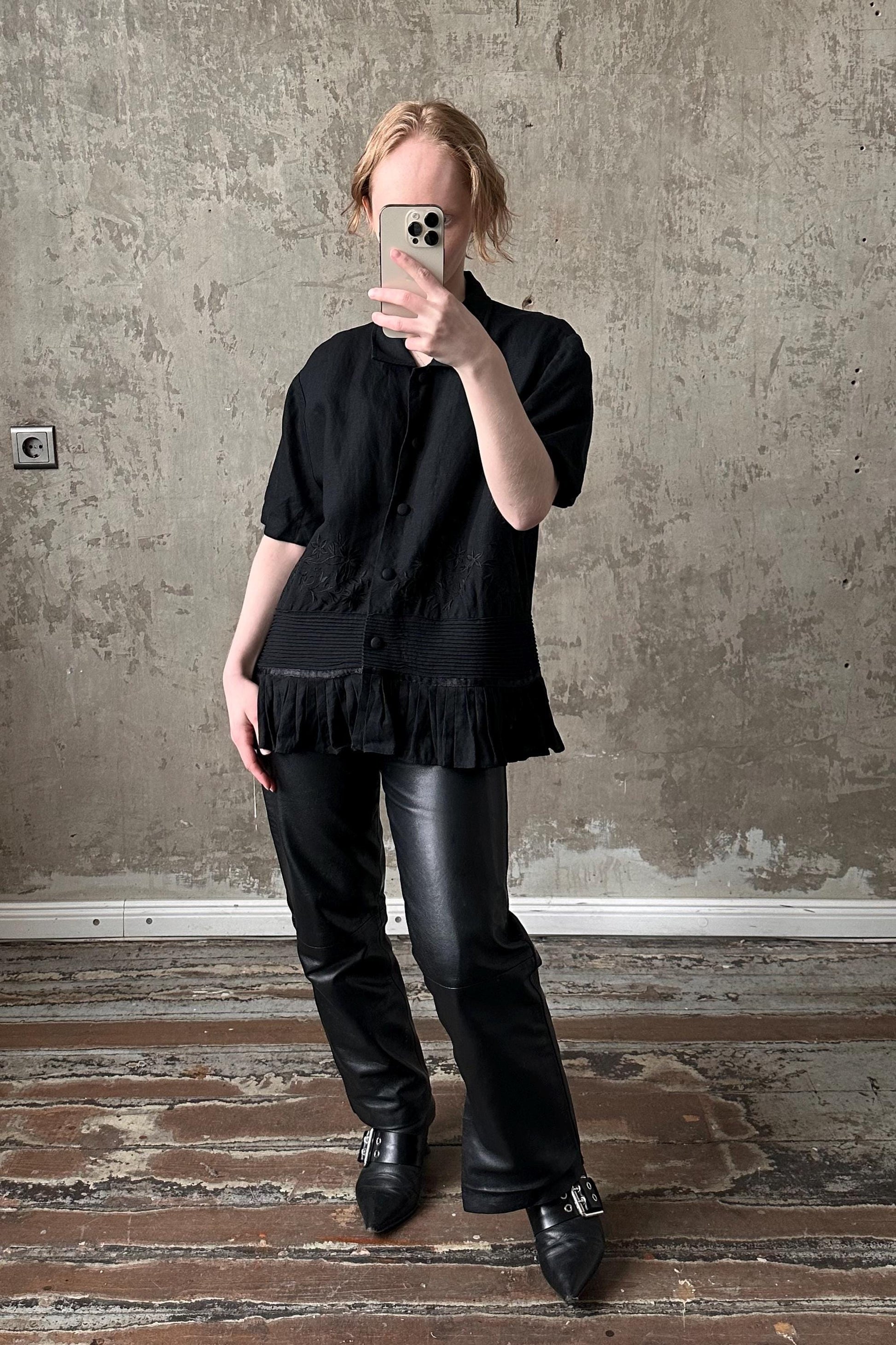 a woman taking a picture of herself in a mirror
