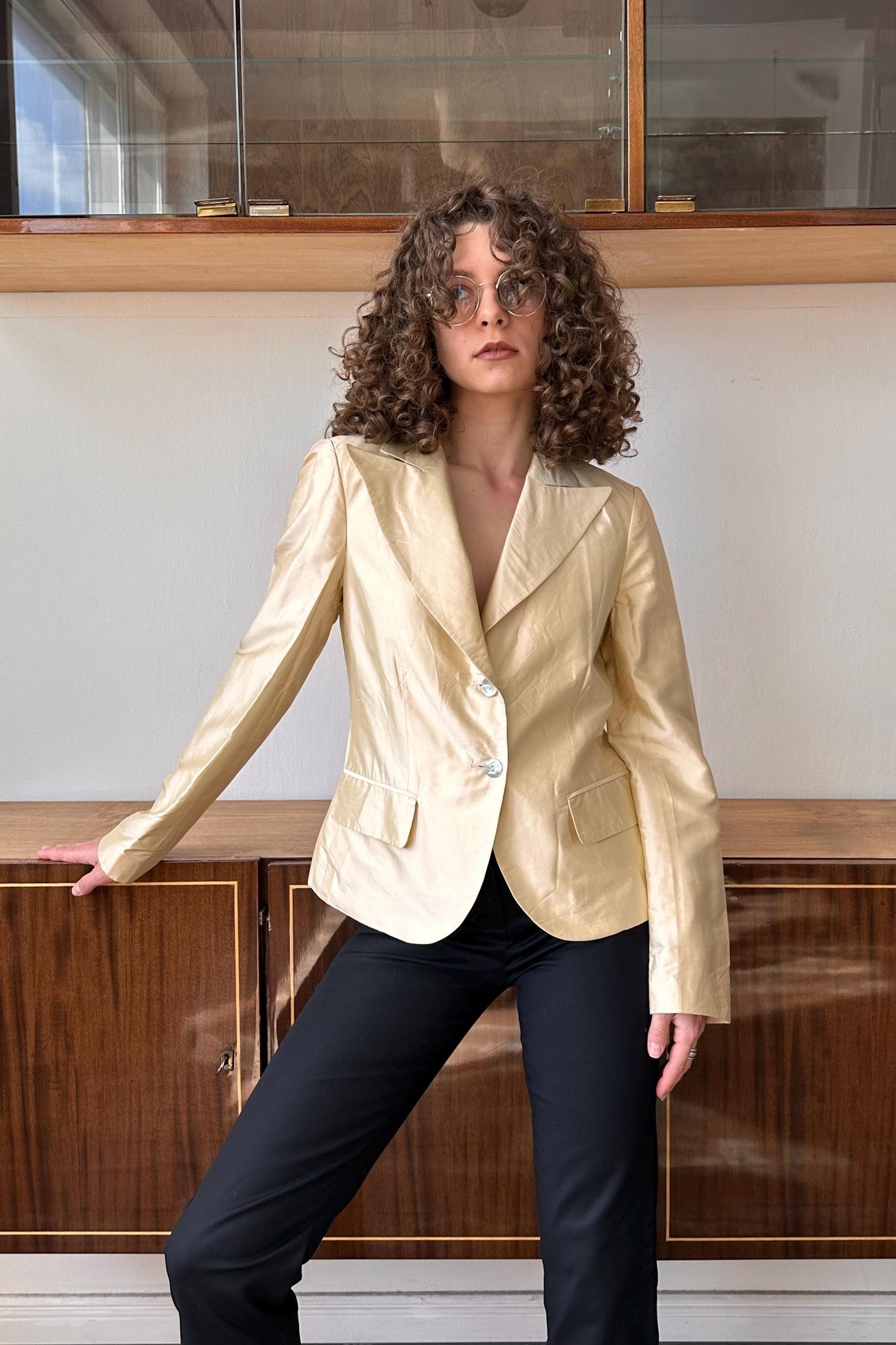 a woman standing in front of a wooden cabinet