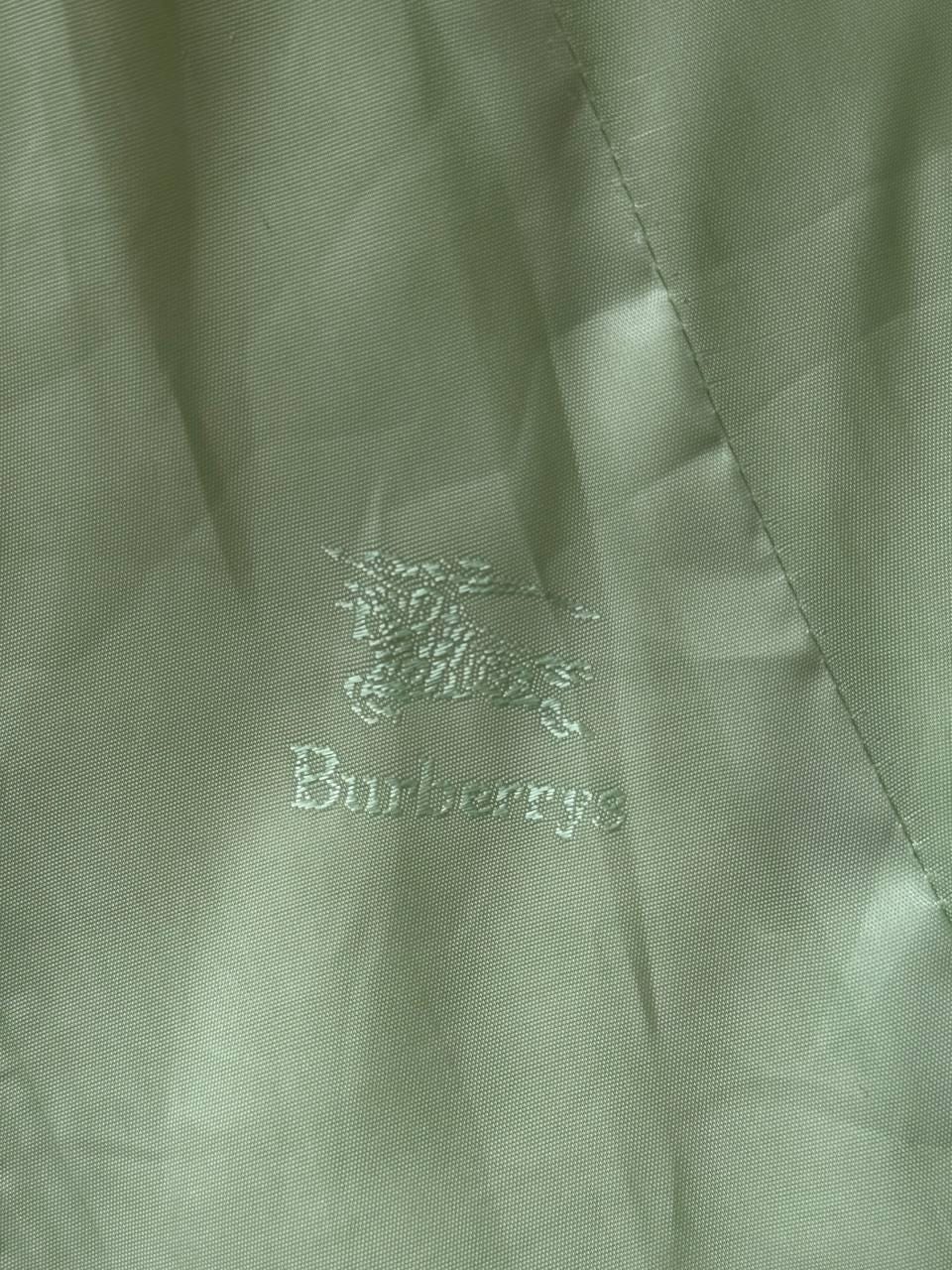 a close-up view of a fabric with a Burberry logo prominently displayed on it.
