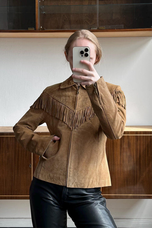 a woman taking a picture of herself in a mirror