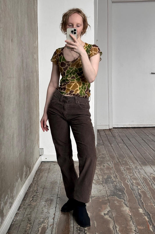 a woman taking a picture of herself in a mirror