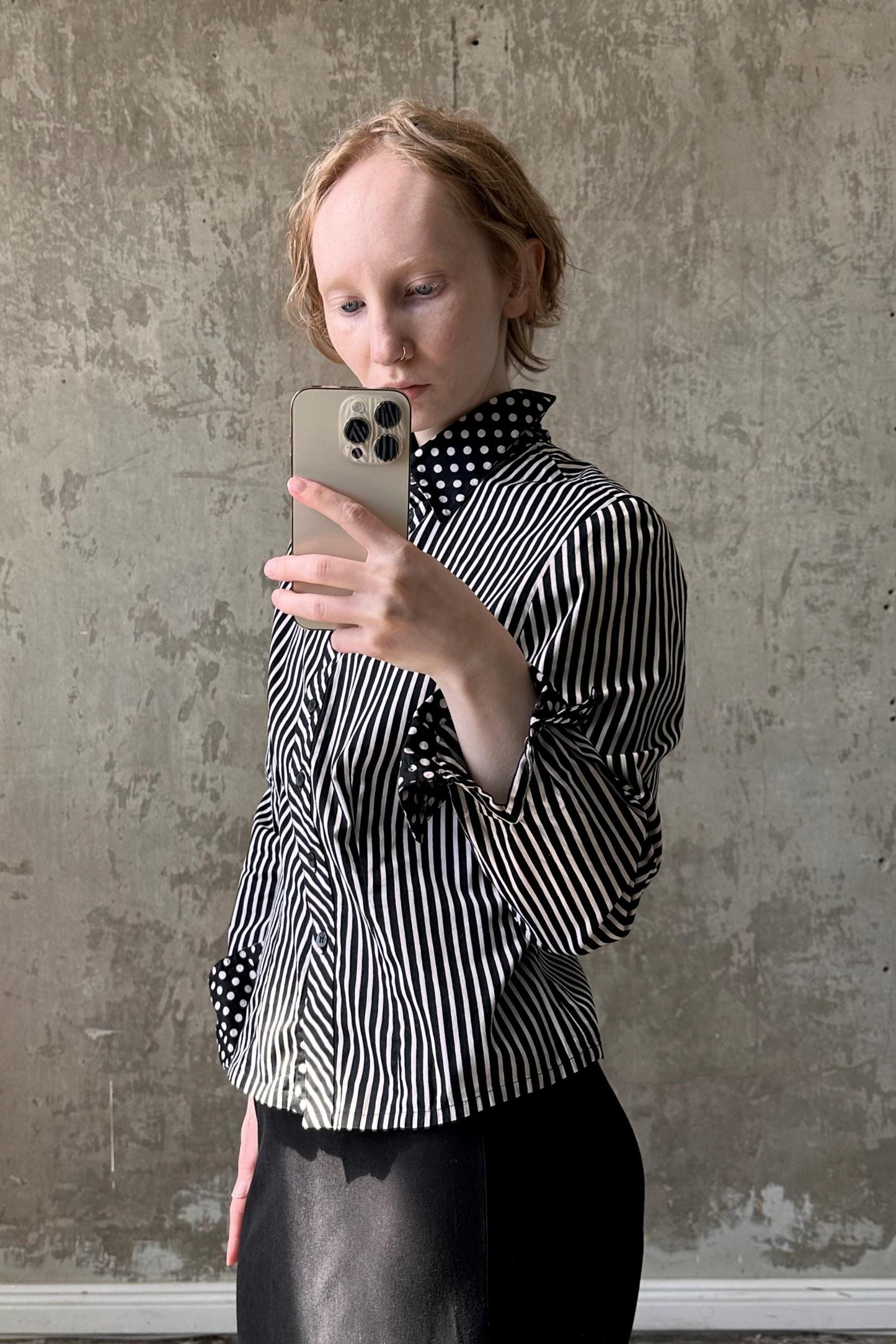 a woman taking a picture of herself with her cell phone