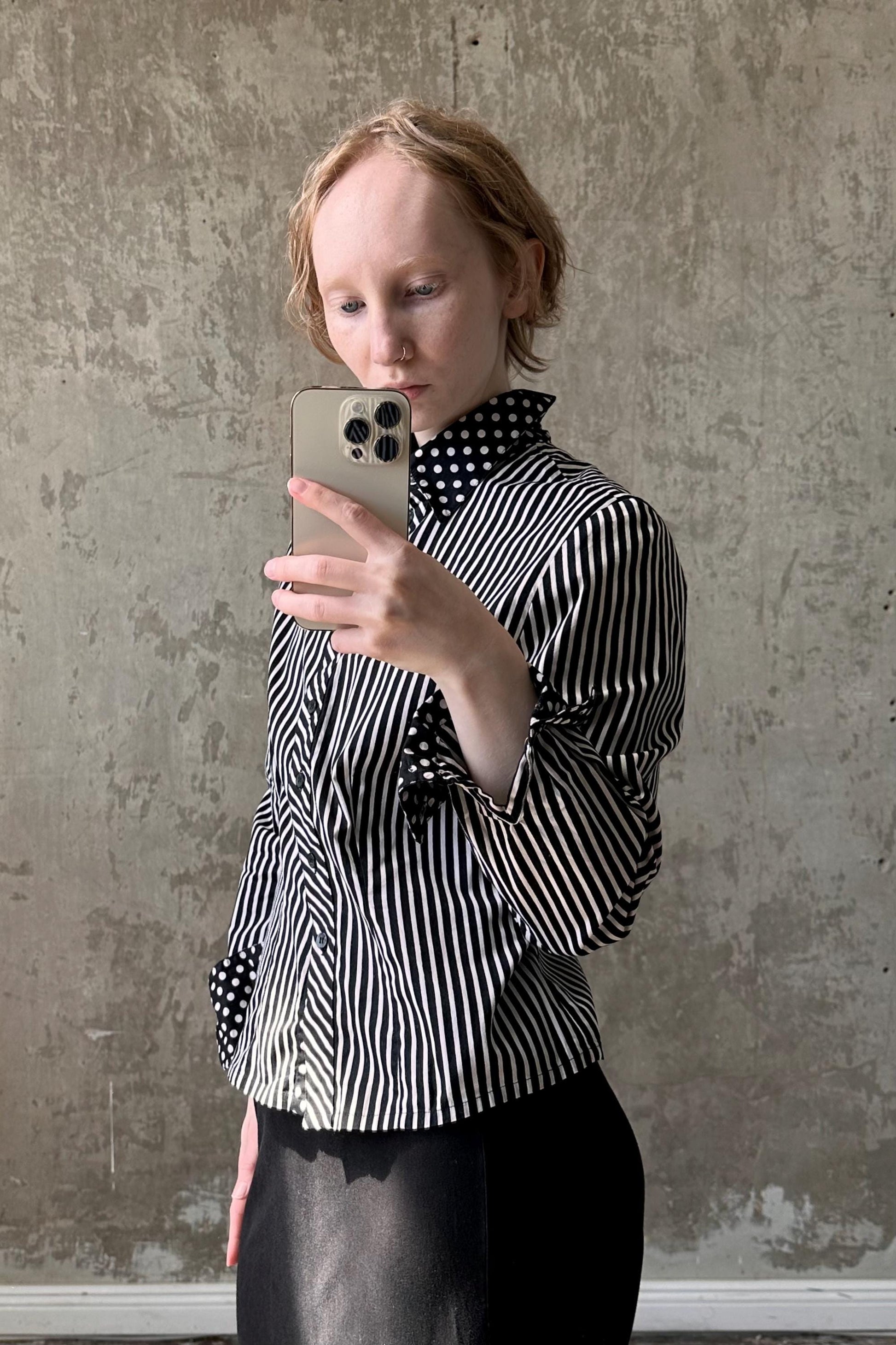 a woman taking a picture of herself with her cell phone