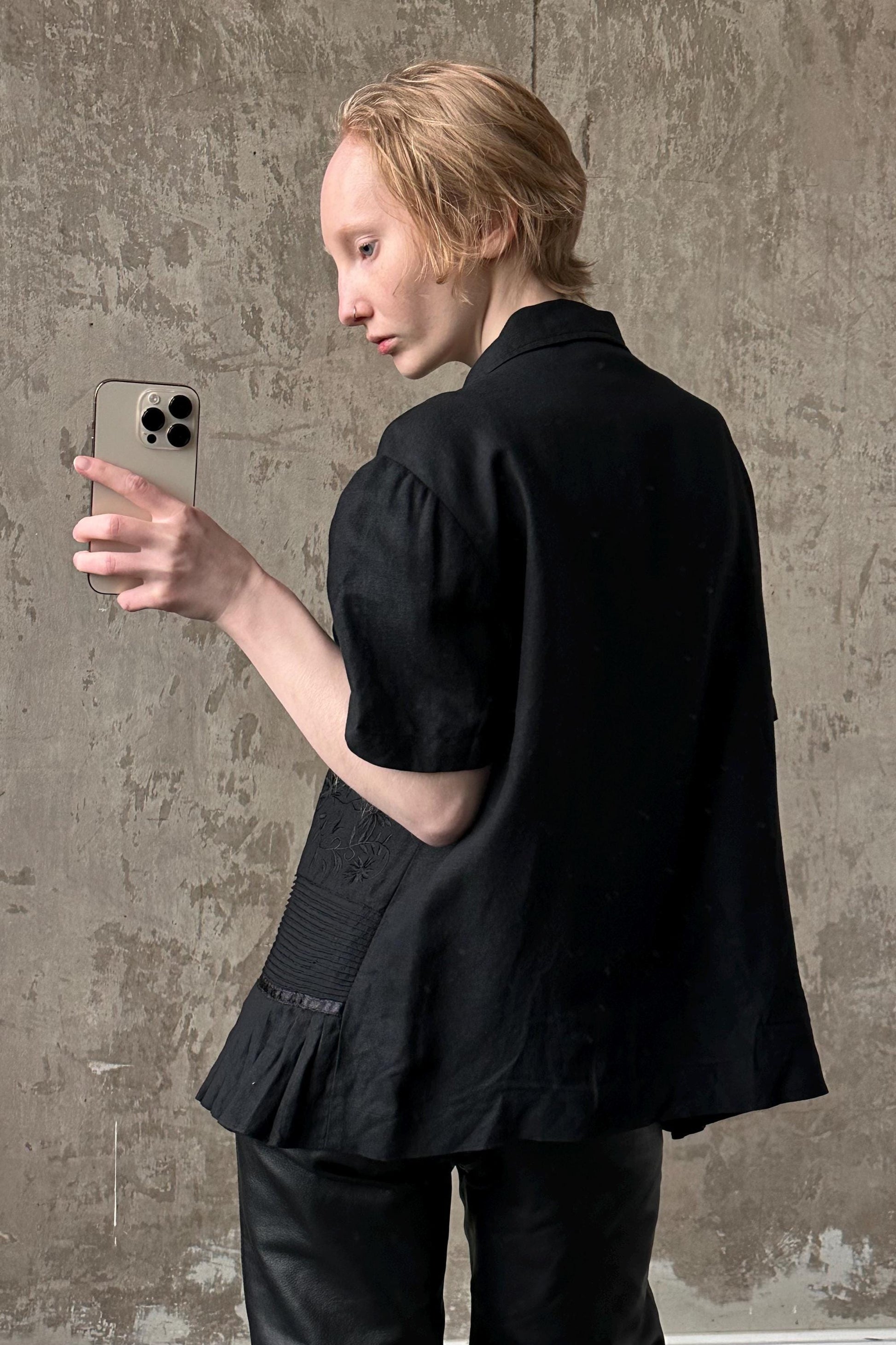 a woman holding a cell phone in her right hand