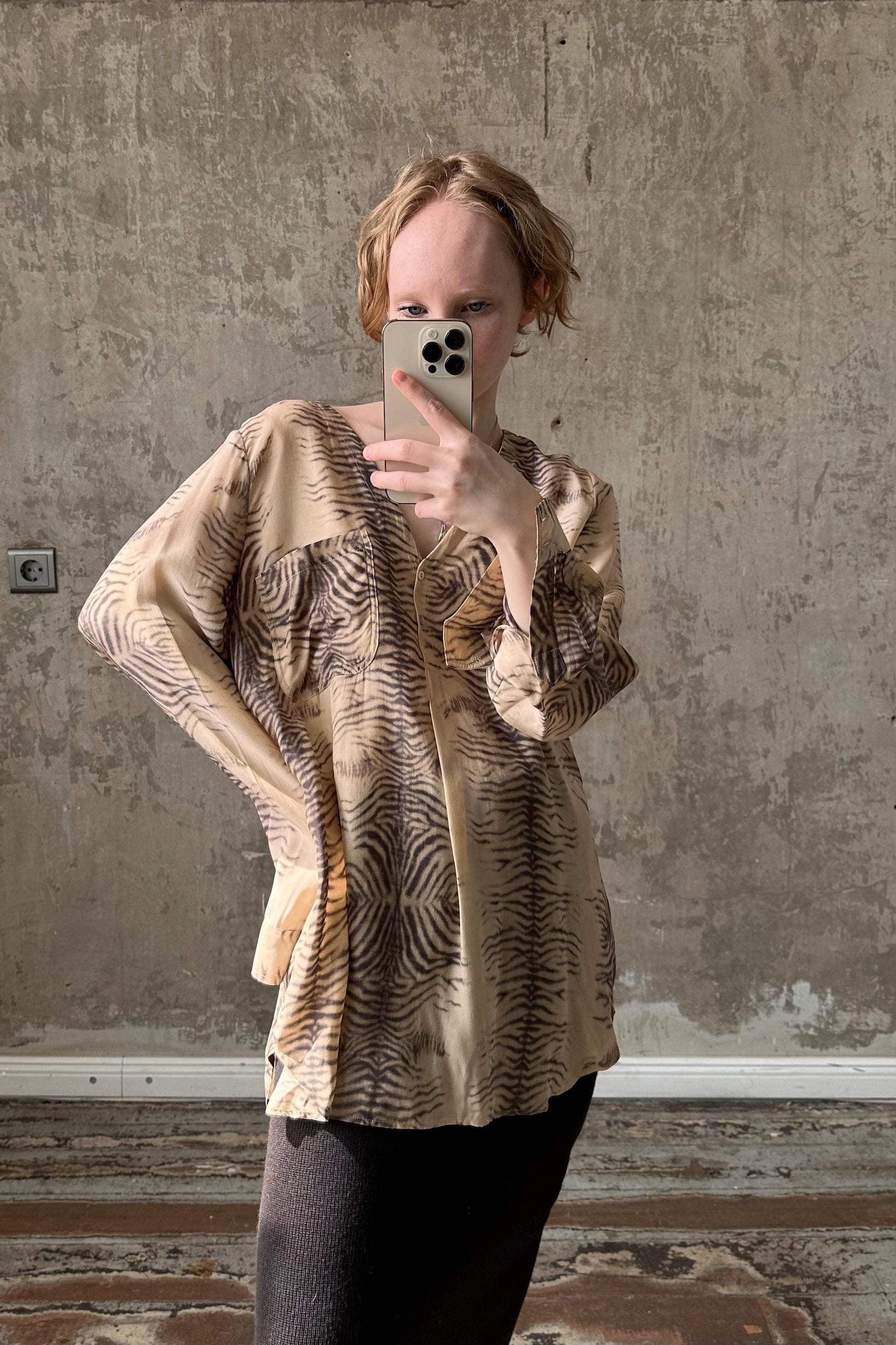 a woman taking a picture of herself in a mirror