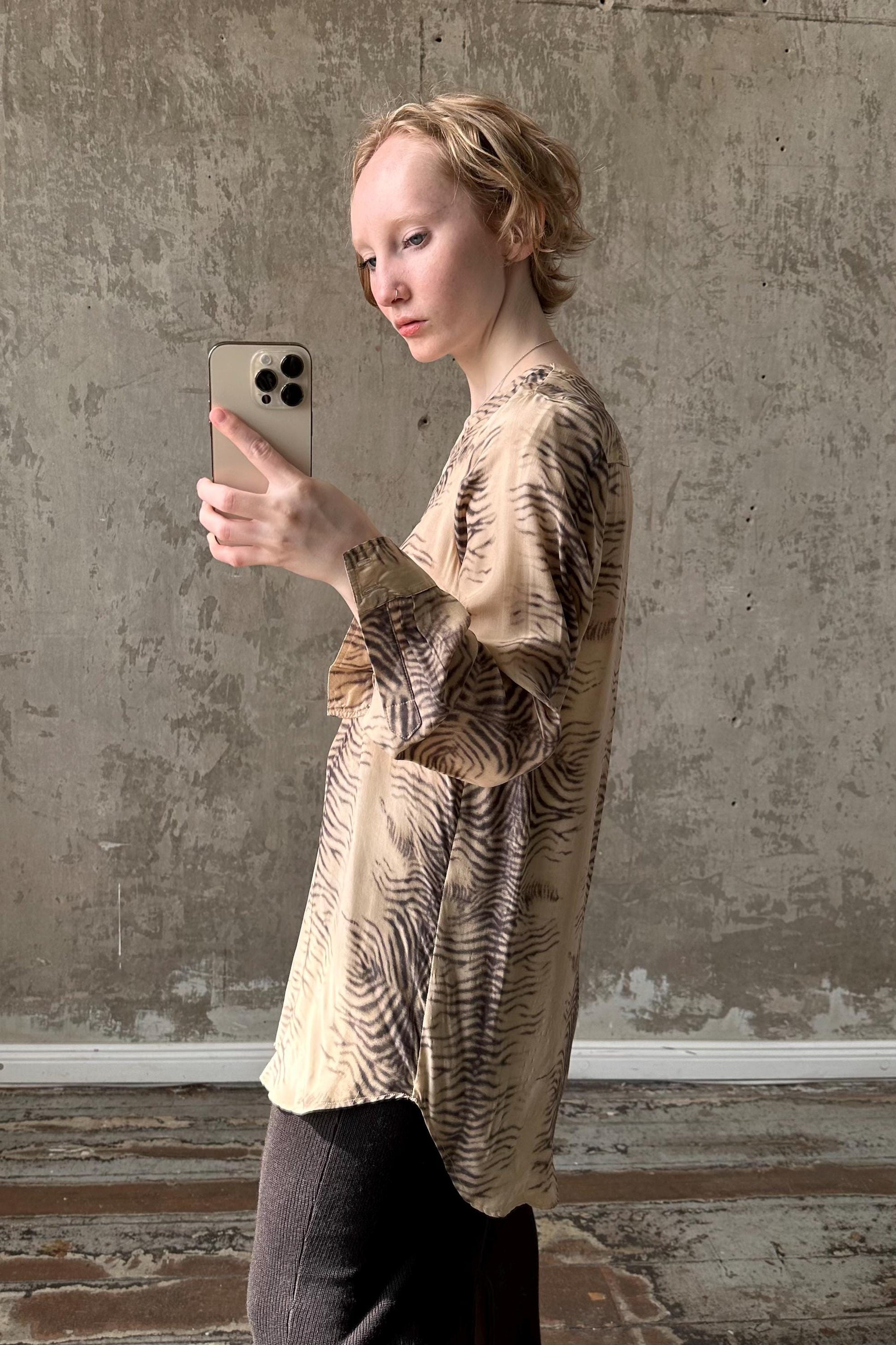 a woman taking a picture of herself with her cell phone