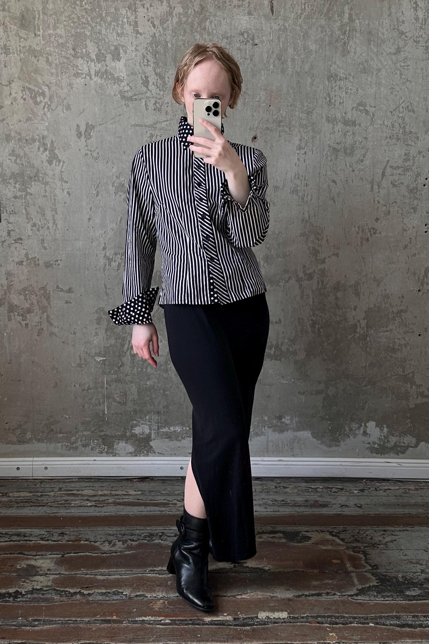 a woman taking a picture of herself in a mirror