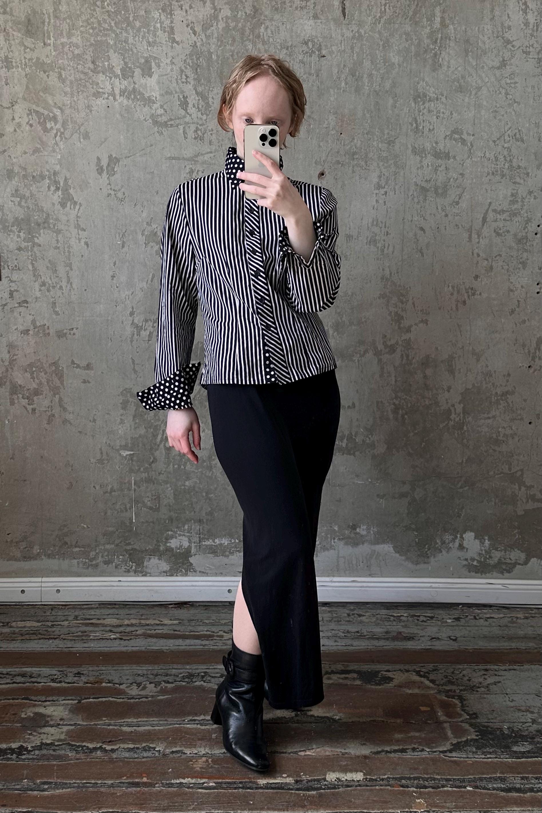 a woman taking a picture of herself in a mirror