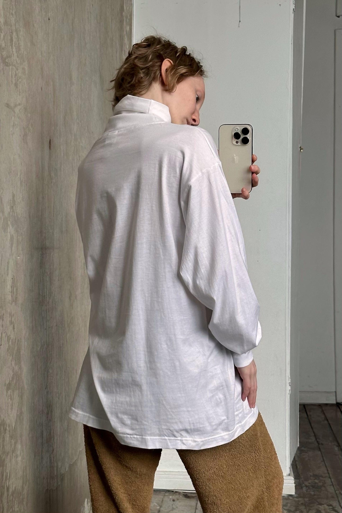 a woman taking a picture of herself in a mirror