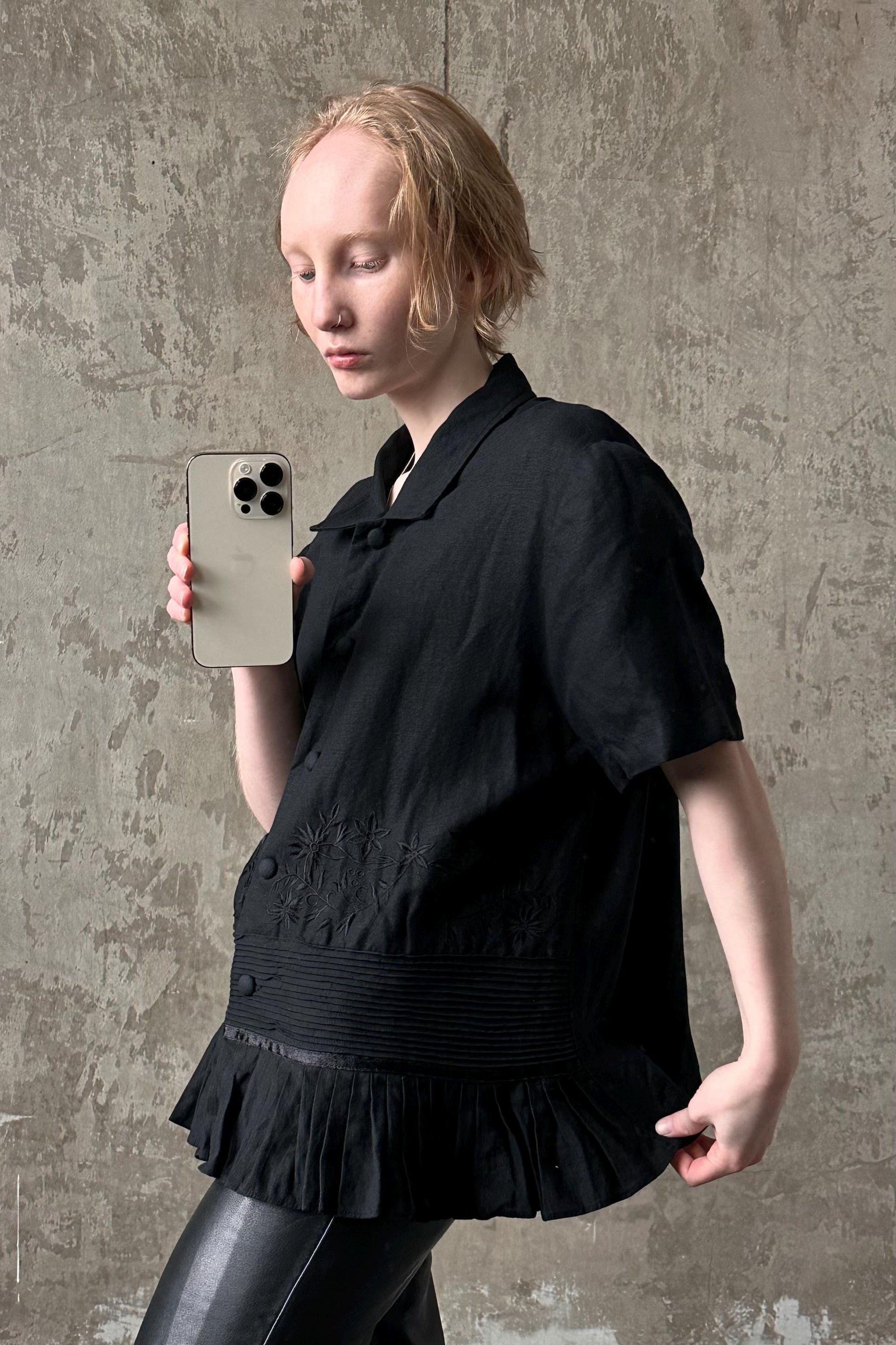 a woman holding a cell phone in her right hand