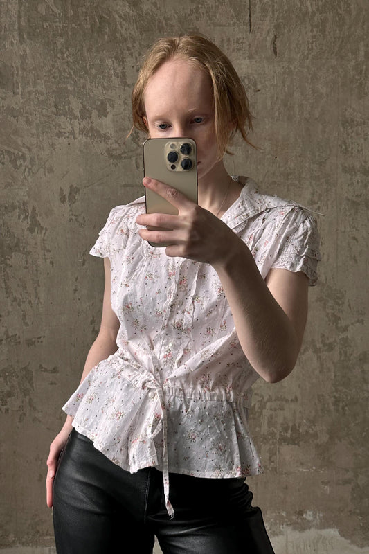 a woman taking a picture of herself with a cell phone
