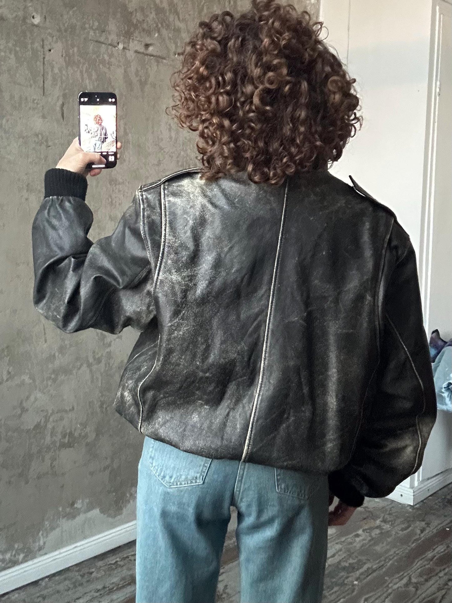 Vintage distressed leather bomber jacket in black with shades